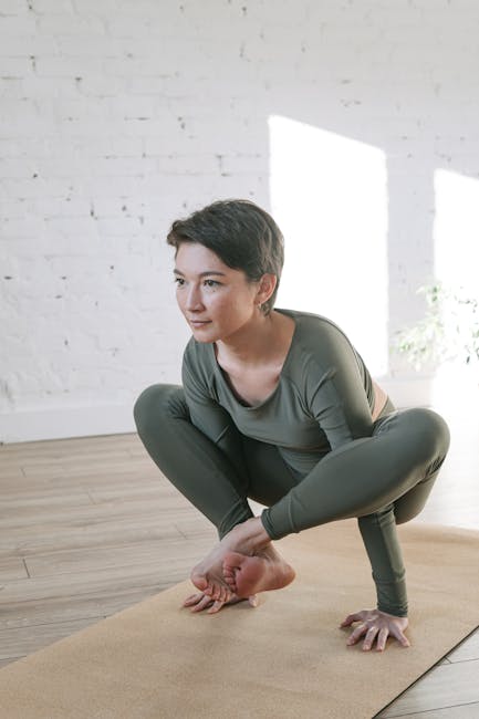 Woman performing a gentle yoga pose in a modern, light-filled room.